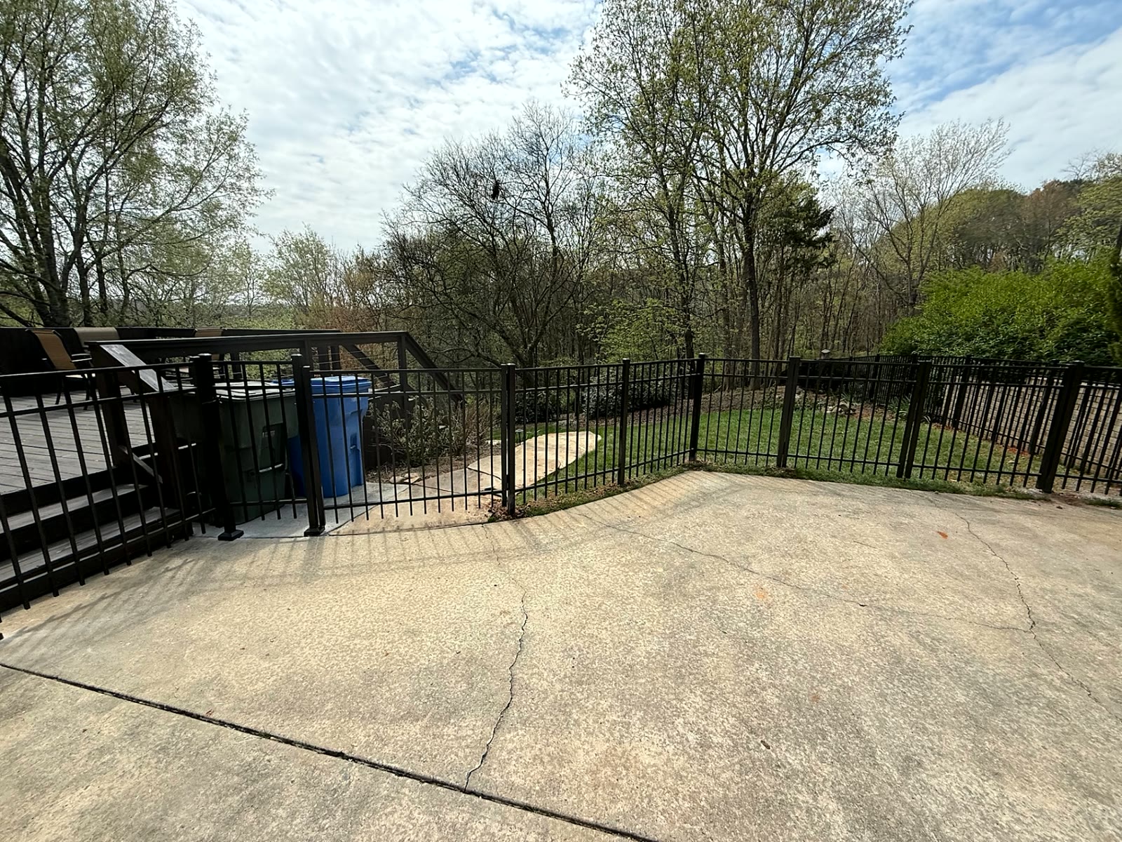 Aluminum fence and gate enclosing a concrete patio